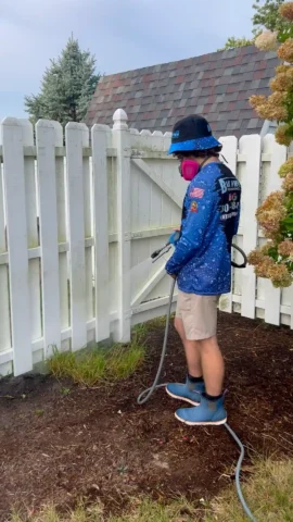 Dirty fence being cleaned by pressure washing in Peoria, IL.