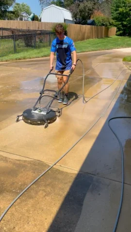 Before-and-after pressure washing of a driveway in Peoria, IL.
